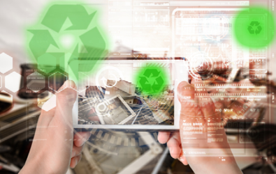 recycling symbol, pile of computers and other electronic devices being captured on a person's mobile device