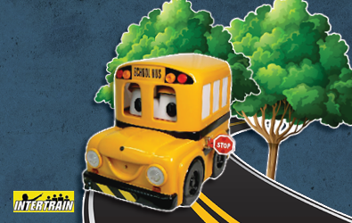 Buster the Bus on a road with a couple of trees in the background