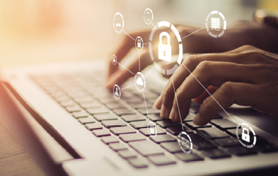hands typing on laptop keyboard with a network transparent layer on top of the keyboard that displays a keylock at the center and other system elements connected such as email messaging and cloud services