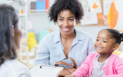 mother and child attending a consult with a woman holding a clipboard