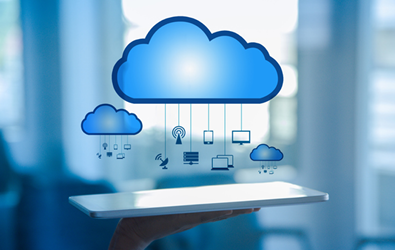 cloud mobiles with wireless, network, satellite, monitor, dual monitors, and mobile device hanging from it, below is a person holding up a tablet