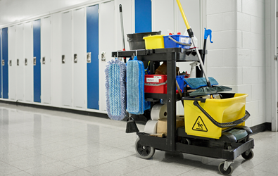 custodial supplies on a cart in an school hallway