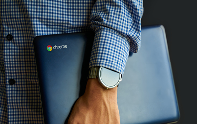 Man holding a chromebook in hand under arm